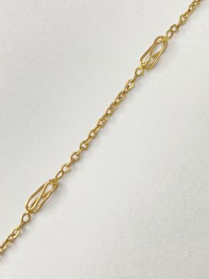 a gold chain bracelet with a heart charm on it