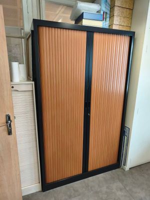 a wooden door with a black handle in a room