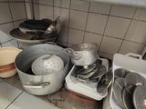 many pots and pans on the counter in the kitchen