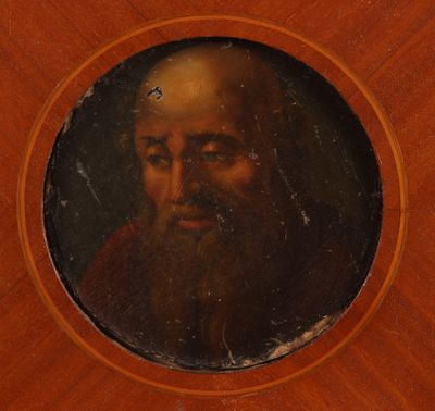 portrait of a man with a beard in a round wooden frame