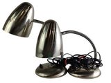 two chrome desk lamps on a white background with wires