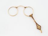 pair of gold - plated glasses and a pair of gold - plated glasses on a white background