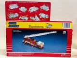 a box with a toy firetruck and a box with a toy firetruck