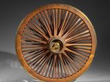 an antique wooden wheel with spokes and spokes on a white surface