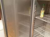 an open refrigerator with a bottle of juice inside of it