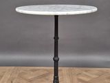 a white marble top table on a wooden floor