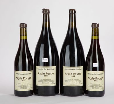 quatre bouteilles de vin sont alignées sur une table