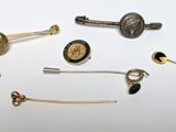 many different types of pins and broochers on a table