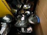 a box full of assorted skates and skateboard gear