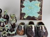 many pieces of pottery that are sitting on a table