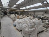 a large warehouse with a lot of bags on the floor