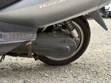 a motorcycle that is parked on a gravel road