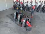 many different types of forklifts lined up in a garage