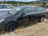 a black car that is parked on the side of the road