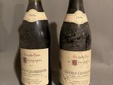 two bottles of wine sitting next to each other on a table