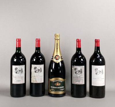 four bottles of wine are lined up on a table