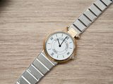 a close up of a wrist watch on a wooden table