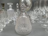 a lot of wine glasses and a decanter on a table