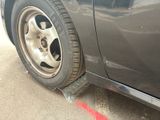 a close up of a car tire on the side of the road