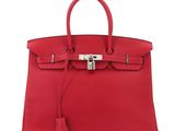a red leather handbag on a white background
