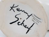 a close up of a white plate with a black writing on it