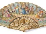 a fan with a painting on it on a white surface