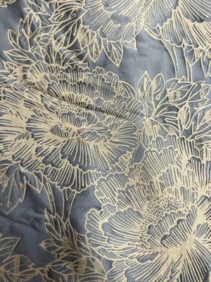 a close up of a blue and white floral pattern on a fabric