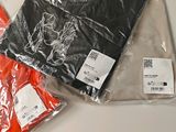 three bags of clothing sitting on a table next to each other