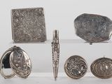 a lot of silver items that are sitting on a table