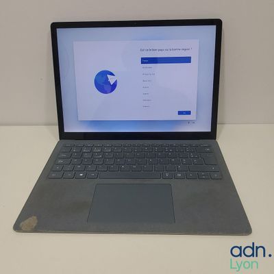 the laptop is sitting on a table with a mouse on top of it