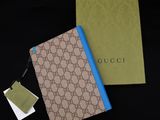 a gucci notebook with a tag on it next to a box