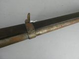 a metal pipe with a piece of paper stuck to it