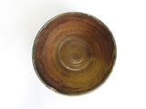 a brown bowl sitting on top of a white table