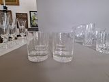 many glasses sitting on a table in a room