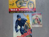 three posters of motorcycles are displayed on a wall in a room