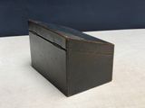 an old wooden box sitting on top of a white table