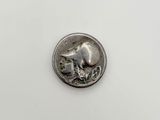 a small silver coin with a small elephant on it