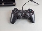 a video game controller sitting next to a charger on a table