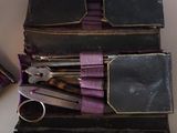 several pairs of scissors are sitting in a case on a table