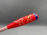 a baseball bat with a design on it that is flying in the air