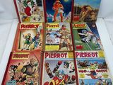 a bunch of comics sitting on top of each other on a table