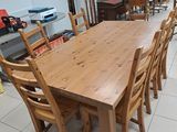 a large wooden table and chairs in a room