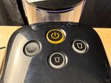 a remote control sitting on a table next to a blender