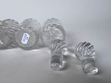 four empty glass bottles sitting on a white surface
