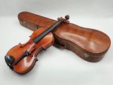 a violin with a case sitting on top of it