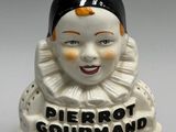 two ceramic figurines of clowns on display