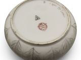 a white bowl with a red and black design on it