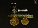 an image of a brass clock and other items on a black surface