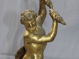 bronze figurine of a man on a horse with a bird in his hand