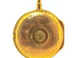a gold pocket watch with a chain on a white background